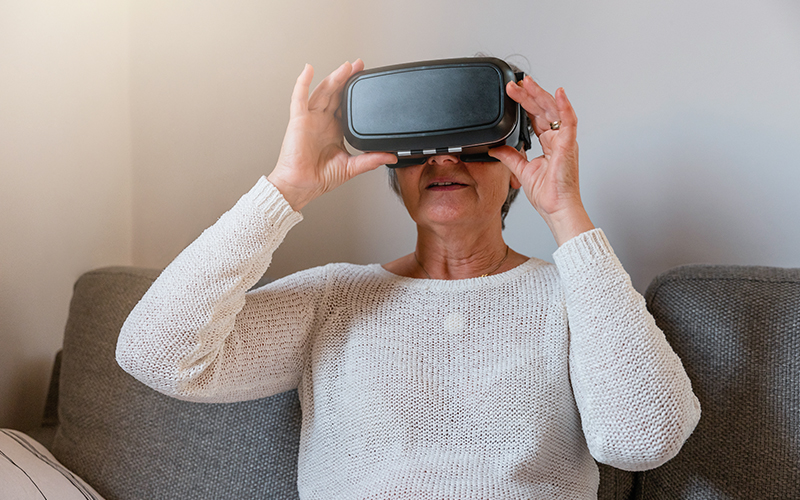Foto de uma pessoa idosa com um óculos de realidade aumentada